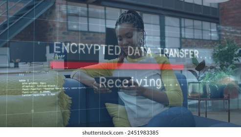 Image of data processing over african american businesswoman using tablet. Global business and digital interface concept digitally generated image.