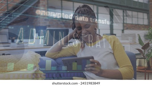Image of data processing over african american businesswoman using tablet. Global business and digital interface concept digitally generated image.
