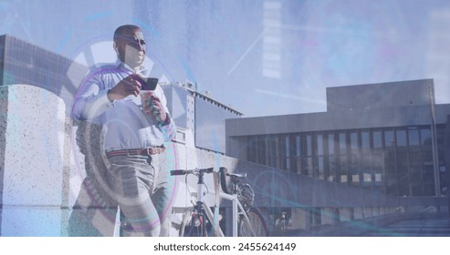 Image of data processing over african american businessman using smartphone. Global business, computing and digital interface concept digitally generated image.