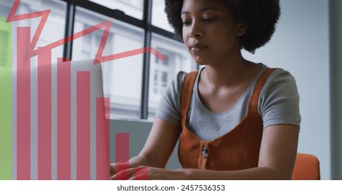 Image of data processing over african american businesswoman using laptop. global business and digital interface concept digitally generated image.