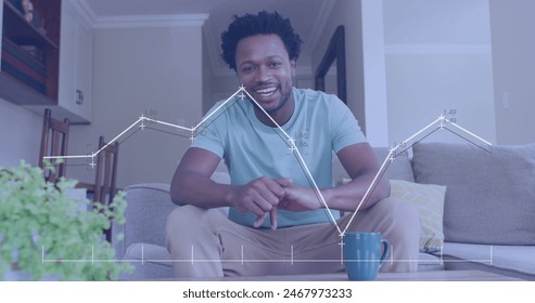 Image of data processing over african american man smiling and talking looking at the camera. Computer interface and business data technology concept