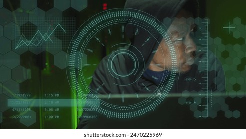 Image of data processing over african american male hacker in server room. Global business, security and digital interface concept digitally generated image.