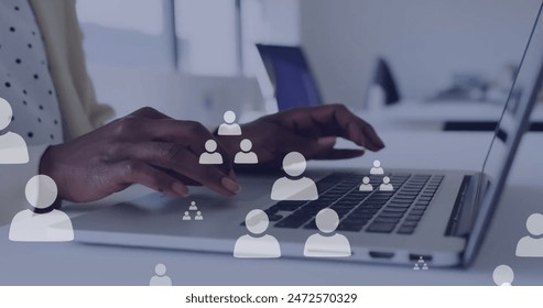 Image of data processing over african american businesswoman using computer in office. Global finance, business and data processing concept digitally generated image.