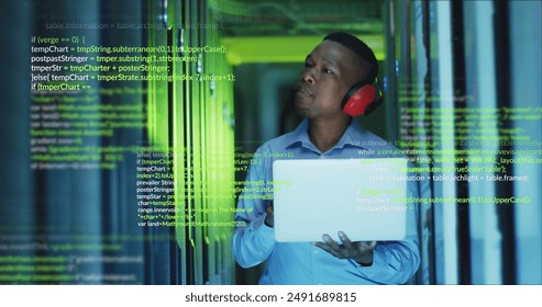Image of data processing over african american male engineer using laptop at server room. Computer interface and business data storage technology concept