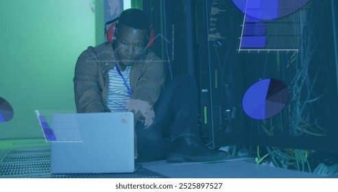 Image of data processing over african american it man by computer servers. Global computing, digital interface and data processing concept digitally generated image.