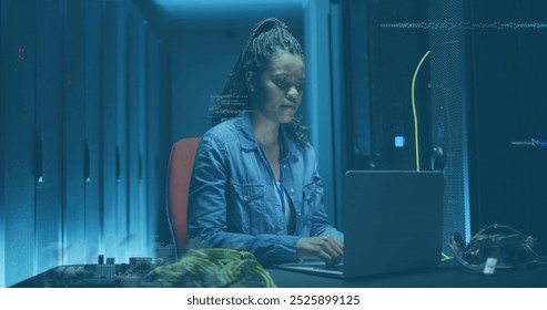 Image of data processing over african american it woman by computer servers. Global computing, digital interface and data processing concept digitally generated image.