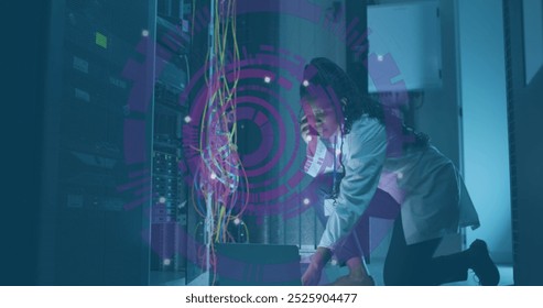 Image of data processing over african american it woman by computer servers. Global computing, digital interface and data processing concept digitally generated image.