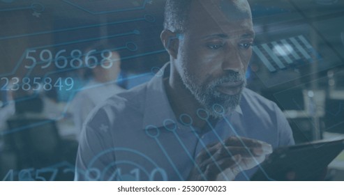 Image of data processing over african american businessman using tablet. global business, finances, connections and digital interface concept digitally generated image.