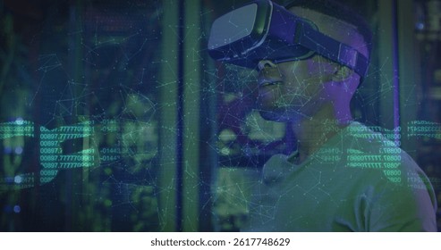 Image of data processing over african american male worker with vr headset in server room. global technology and digital interface concept digitally generated image.