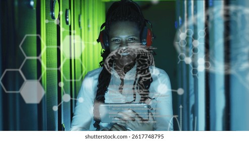 Image of data processing over african american female worker in server room. global business, cloud computing and digital interface concept digitally generated image.