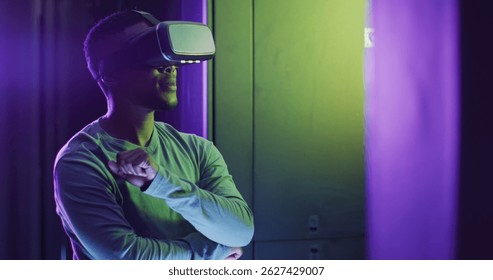 Image of data processing over african american man using vr headset in server room. Cloud computing, digital interface and security concept digitally generated image.