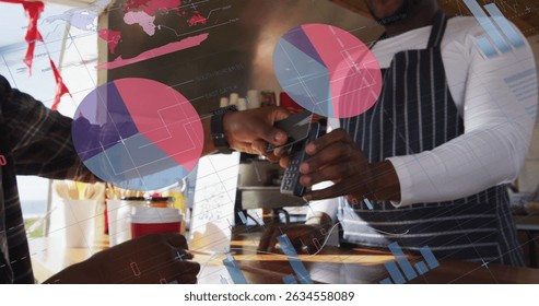 Image of data processing over african american man paying with credit card. Global business and digital interface concept digitally generated image.