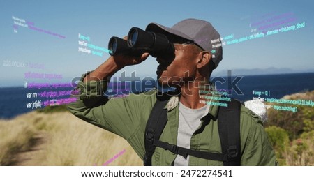 Image of data processing over african american man using binoculars in nature. Global travel, fitness, digital interface and data processing concept digitally generated image.