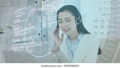 Image of data processing over asian businesswoman wearing phone headset using laptop at office. Business data and analytics technology concept