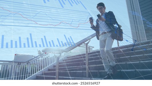 Image of data processing over asian man using smartphone while climbing down the stairs. Business data technology concept - Powered by Shutterstock