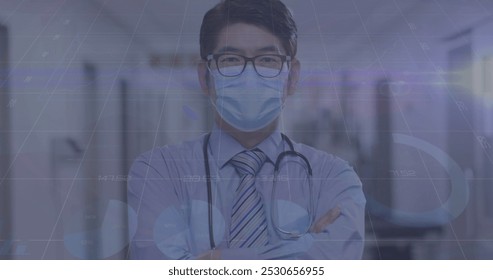 Image of data processing over asian male doctor with face mask. global medicine and data processing during covid 19 pandemic concept digitally generated image.