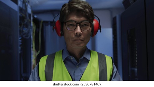 Image of data processing over asian male worker in server room. Global business and digital interface concept digitally generated image.