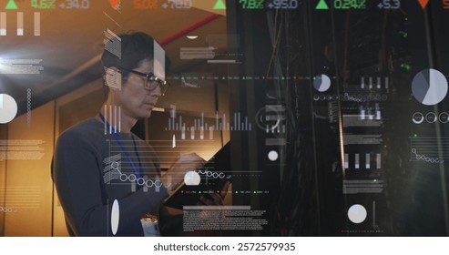 Image of data processing over asian male it engineer by computer servers. Global finance, business, connections, computing and data processing concept digitally generated image.
