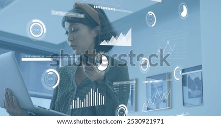 Image of data processing over asian businesswoman working at office. Global business and digital interface concept digitally generated image.