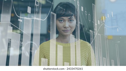Image of data processing over biracial businesswoman smiling. Global business and digital interface concept digitally generated image.
