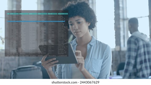 Image of data processing over biracial businesswoman using tablet in office. Global business, technology and digital interface concept digitally generated image.