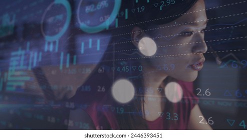 Image of data processing over biracial businesswoman working in office. Global business, finances, computing and data processing concept digitally generated image.
