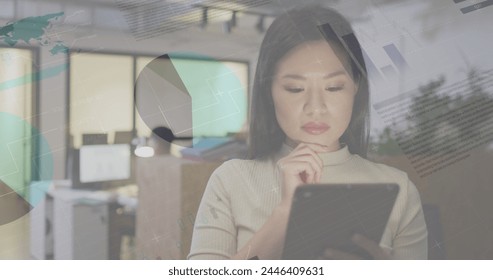 Image of data processing over biracial businesswoman working in office. Global business, finances, computing and data processing concept digitally generated image.