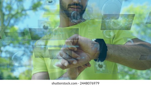 Image of data processing over biracial sportsman checking smartwatch. Global sport and digital interface concept digitally generated image. - Powered by Shutterstock