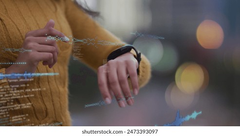 Image of data processing over biracial woman using smartwatch. Global business, data processing and digital interface concept digitally generated image. - Powered by Shutterstock