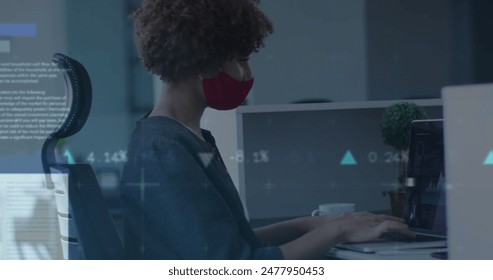 Image of data processing over biracial businesswoman with face mask in office. Global business and digital interface concept digitally generated image.