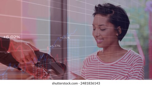 Image of data processing over biracial woman paying in shop. Global business and digital interface concept digitally generated image.