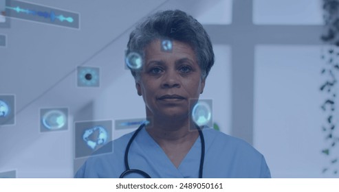 Image of data processing over biracial female doctor smiling. Global medicine and digital interface concept digitally generated image.