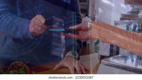 Image of data processing over biracial man paying with smartphone. Technology, communication, computing and digital interface concept digitally generated image.