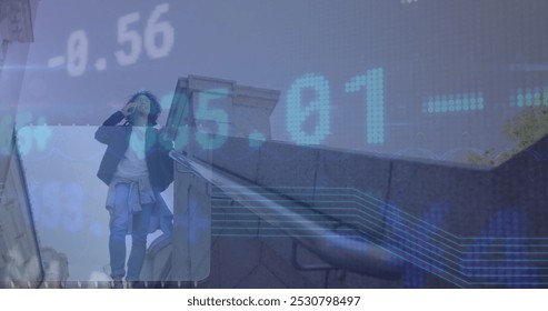 Image of data processing over biracial businessman talking on smartphone. Global business and digital interface concept digitally generated image. - Powered by Shutterstock