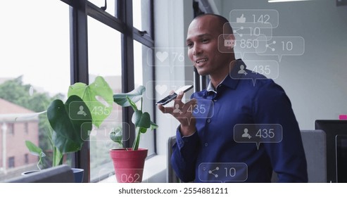 Image of data processing over biracial businessman talking on smartphone in office. Global social media, business and digital interface concept digitally generated image. - Powered by Shutterstock