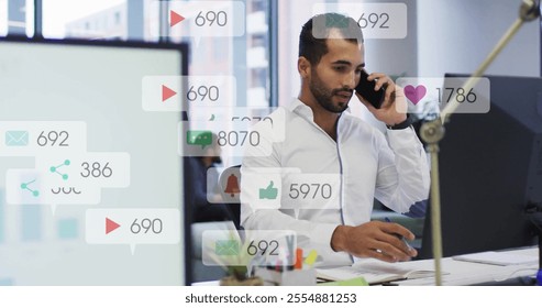 Image of data processing over biracial businessman talking on smartphone in office. Global social media, business and digital interface concept digitally generated image. - Powered by Shutterstock