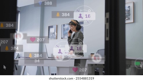 Image of data processing over biracial businesswoman talking on smartphone in office. Global social media, business and digital interface concept digitally generated image. - Powered by Shutterstock