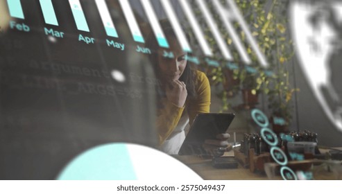 Image of data processing over biracial businesswoman using tablet in office. Global finance, business, connections, computing and data processing concept digitally generated image.