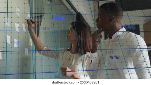 Image of data processing over business people in office. Global business, finance, connections, networks and data processing concept digitally generated image.