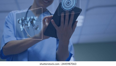 Image of data processing over caucasian female doctor using tablets. Global medicine, healthcare and data processing concept digitally generated image.