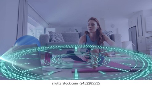 Image of data processing over caucasian woman exercising, using laptop. Global online vlogging, fitness, digital interface and connections concept digitally generated image.