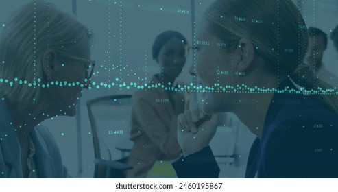 Image of data processing over caucasian businesswoman whispering in ear of another businesswoman. Business data technology concept - Powered by Shutterstock