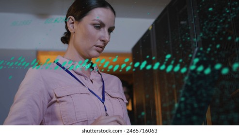 Image of data processing over caucasian female worker in server room. global business and digital interface concept digitally generated image.