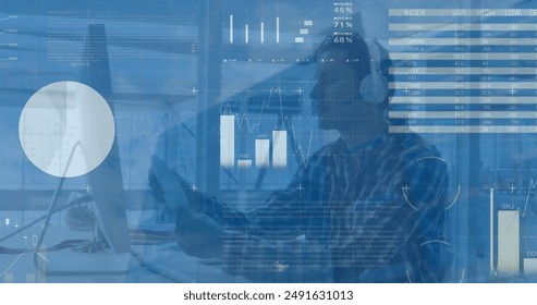 Image of data processing over caucasian man wearing headphones using computer at office. Business data technology concept