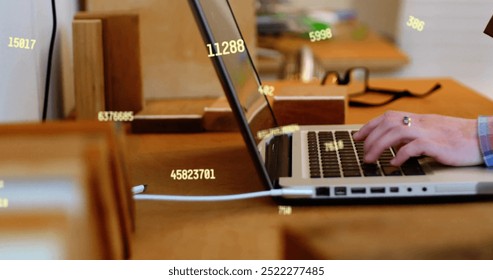 Image of data processing over caucasian businessman using laptop in office. Global business, office, computing and digital interface concept digitally generated image.