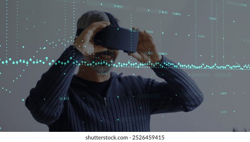 Image of data processing over caucasian man with vr headset. Global business and digital interface concept, digitally generated image.
