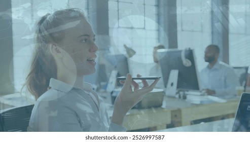 Image of data processing over caucasian businesswoman talking on smartphone in office. global business, computing and digital interface concept digitally generated image.