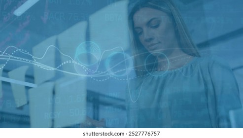 Image of data processing over caucasian businesswoman in office. Global finance, business, connections, computing and data processing concept digitally generated image.