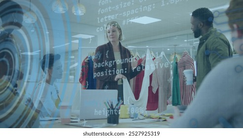 Image of data processing over caucasian female fashion designer holding a t-shirt discussing. Computer interface and business technology concept - Powered by Shutterstock