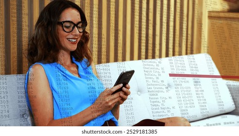 Image of data processing over caucasian woman smiling while using smartphone at office. Computer interface and business technology concept